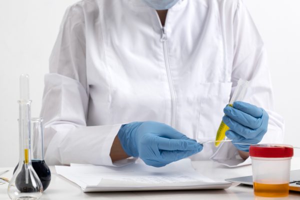 lab doctor performing medical exam urine